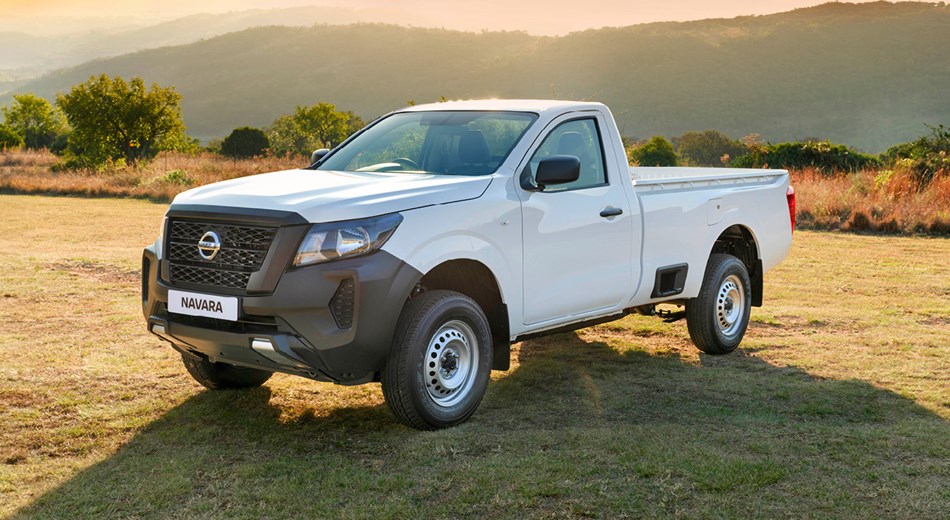 3/4 view of white single cab Nissan Navara in an open field