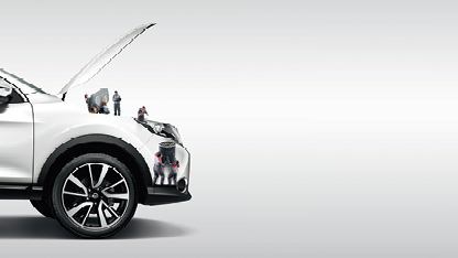 Tiny mechanics working on a Nissan Engine